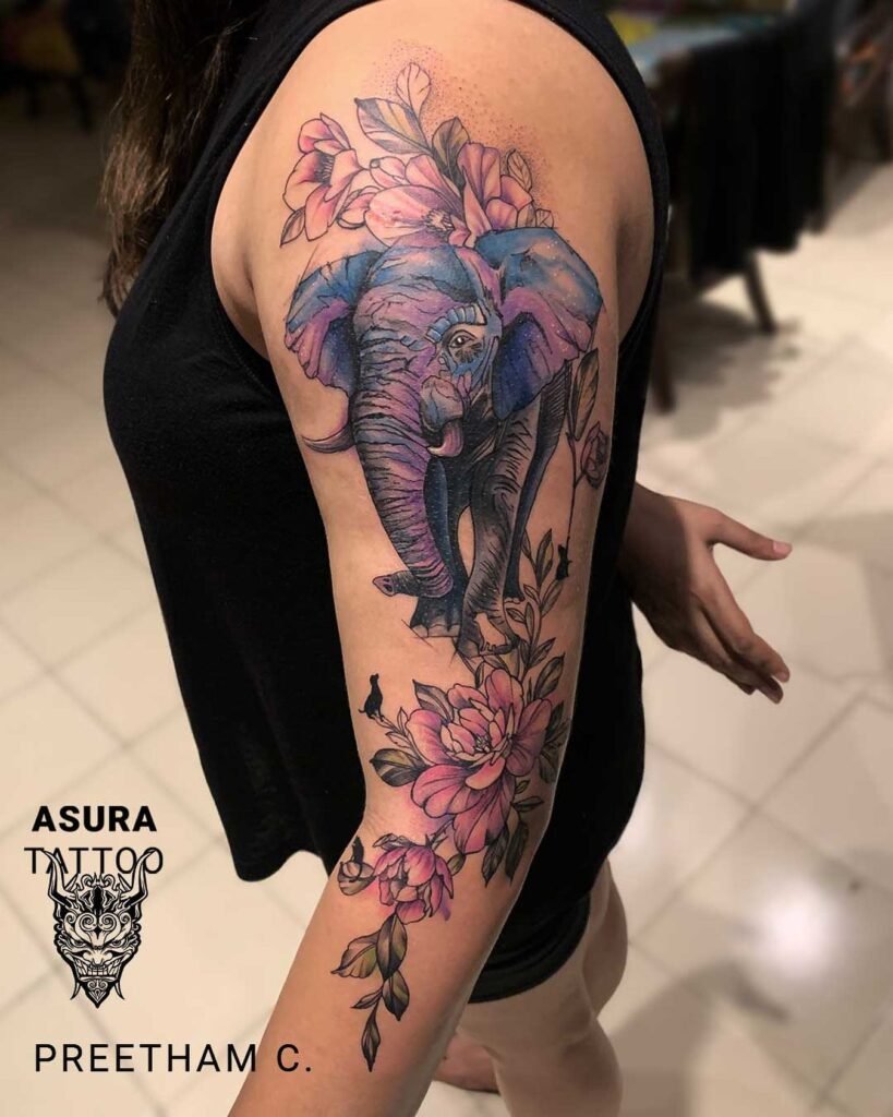 Elephant Tattoo Ideas for Males and Females 2 Elephant Tattoo with Floral Combination Design in Water Color Style with Purple, Pink and Blue Combination - Full Sleeve, Upper Arms Position. - Female Tattoo